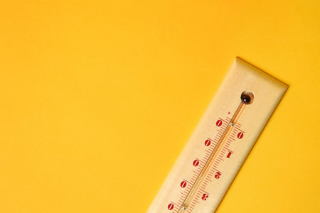 Weather thermometer on yellow background, top view. Space for textの写真素材