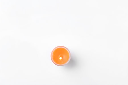 Orange candle isolated on white, top viewの写真素材