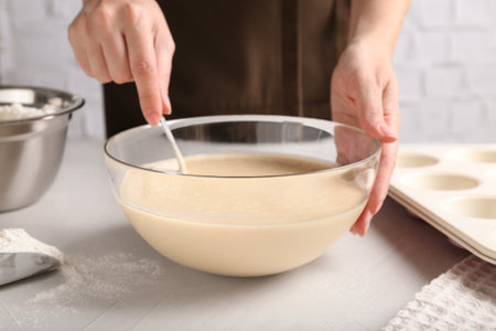 Woman making batter at light table, closeupの写真素材