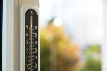 Weather thermometer on window frame indoors, closeup. Space for textの写真素材