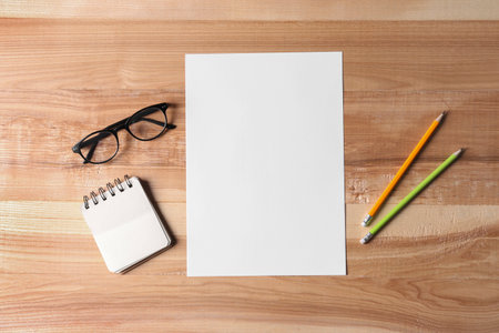 Flat lay composition with blank paper sheet on wooden background. Space for text