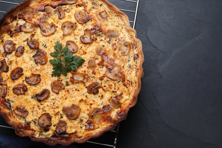 Delicious homemade mushroom pie on black table, top view. Space for textの写真素材