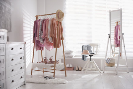 Rack with stylish women's clothes indoors. interior designの写真素材