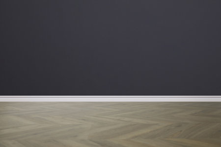 Wooden floor and empty dark wall indoorsの写真素材