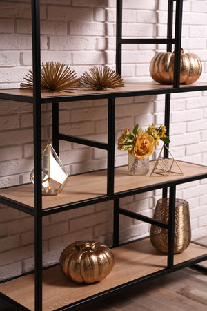 Shelving with different decor near white brick wall. Interior designの写真素材