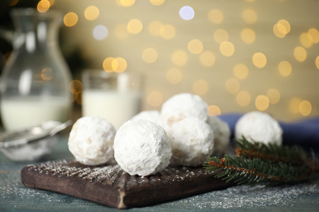 Christmas snowball cookies and fir tree branch on table, closeup. Space for textの写真素材