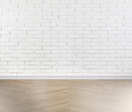 Wooden floor and white brick wall indoorsの写真素材