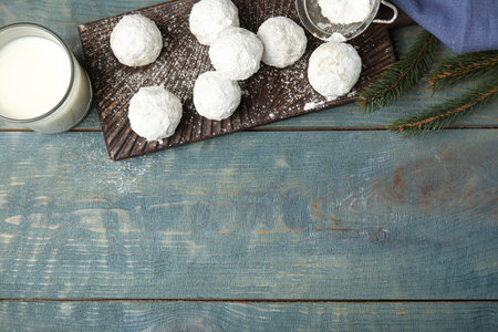 Flat lay composition with tasty Christmas snowball cookies on blue wooden table. Space for textの写真素材