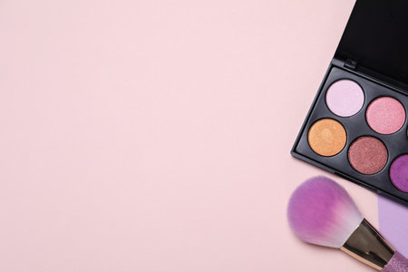 Eyeshadow palette and makeup brush on color background, flat lay with space for textの写真素材