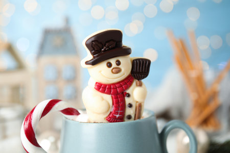 Funny chocolate snowman candy in cup of hot drink, closeupの写真素材