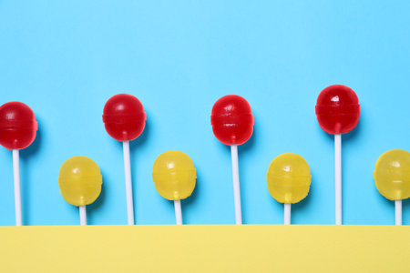 Sweet lollipops on light blue background, flat layの写真素材