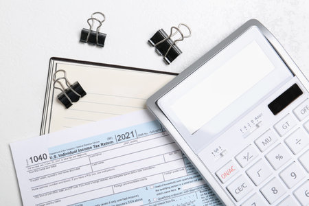 Calculator, document, notebook and clips on table, flat lay. tax accountingの写真素材
