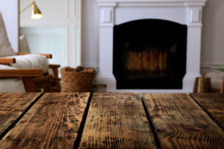 Empty wooden surface and blurred view of fireplace in roomの写真素材