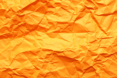 Texture of orange crumpled paper as background, closeupの写真素材