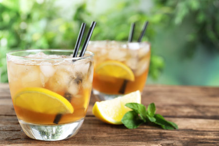 Delicious iced tea on wooden table outdoorsの写真素材