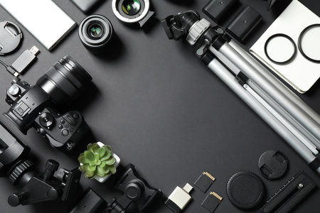 Flat lay composition with camera and video production equipment on black background. Space for textの写真素材