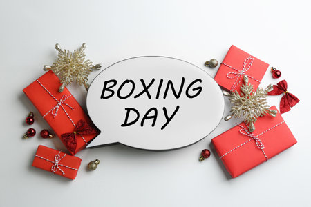 Speech bubble with phrase BOXING DAY and Christmas decorations on white background, flat layの写真素材