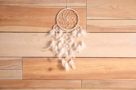 Beautiful dream catcher hanging on wooden wallの写真素材