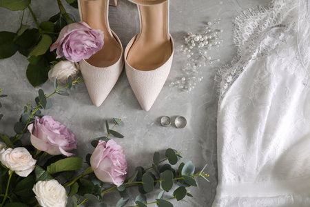 Flat lay composition with white wedding dress and shoes on grey marble tableの写真素材