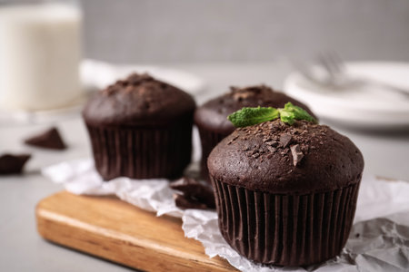 Delicious chocolate muffins served on grey table, closeup. Space for textの写真素材