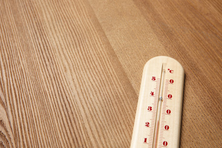 Weather thermometer on wooden table, closeup. Space for textの写真素材