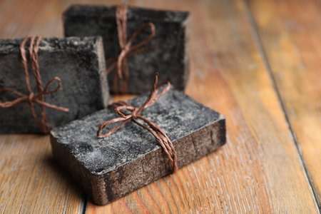 Natural tar soap on wooden table, closeupの写真素材