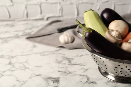 Fresh vegetables on white marble table, closeup. Space for textの写真素材