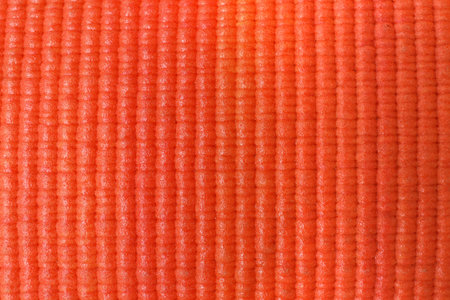 Orange foam rubber mat as background, top viewの写真素材