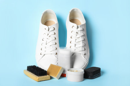 Composition with stylish footwear and shoe care accessories on light blue backgroundの写真素材