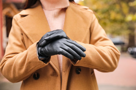 Young woman in black leather gloves, closeup. Stylish clothesの写真素材