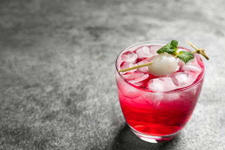 Delicious lychee cocktail with mint on grey table. Space for textの写真素材
