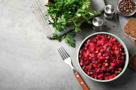 Traditional Russian salad vinaigrette served on grey table, flat lay. Space for textの写真素材