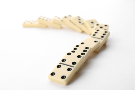 Fallen light domino tiles on white backgroundの写真素材