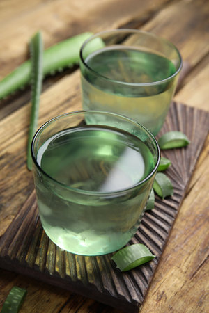 Fresh aloe drink in glasses on wooden tableの写真素材