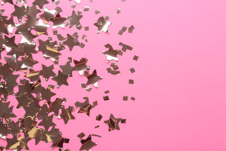 Shiny confetti on pink background, flat lay. Space for textの写真素材