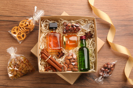 Box with stylish craft gift set on wooden table, flat layの写真素材
