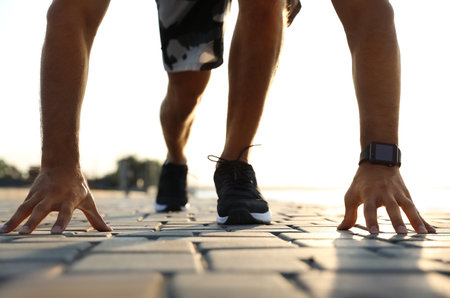 Man with fitness tracker training outdoors, closeupの写真素材