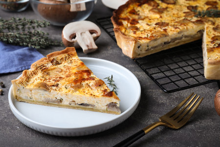 Delicious pie with mushrooms and cheese served on gray tableの写真素材