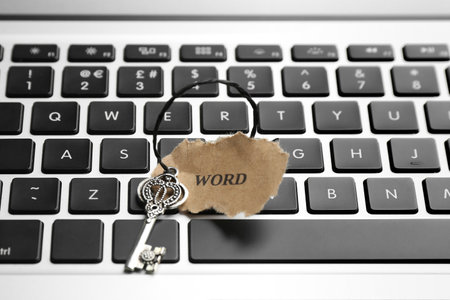 Key with tag WORD on laptop keyboard, closeup. Keyword conceptの写真素材