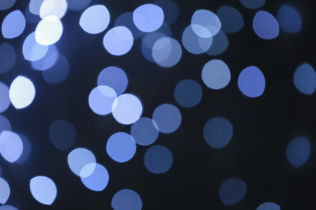 Blurred view of beautiful lights on dark backgroundの写真素材