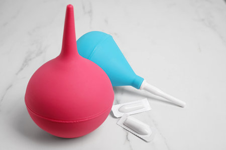 Different enemas and suppositories on white table. medical treatmentの写真素材