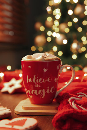 Tasty hot drink in cup with inscription Believe in Magic. christmas atmosphereの写真素材