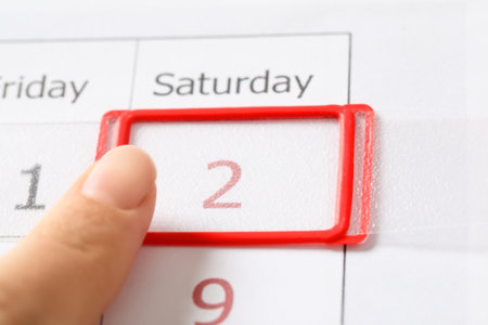 Woman moving date slider on calendar onto February 2nd, closeup. Groundhog dayの写真素材