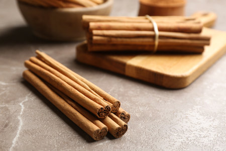Aromatic cinnamon sticks on gray table. Space for textの写真素材