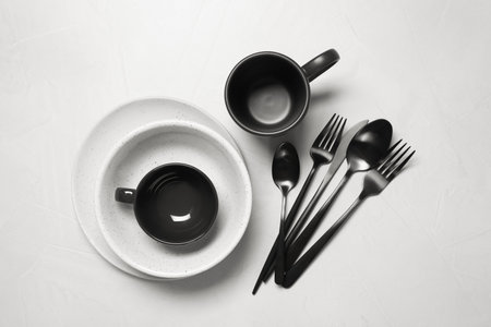 Flat lay composition with dishware and cutlery on white tableの写真素材