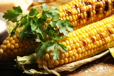 Delicious grilled sweet corn cobs on board, closeupの写真素材