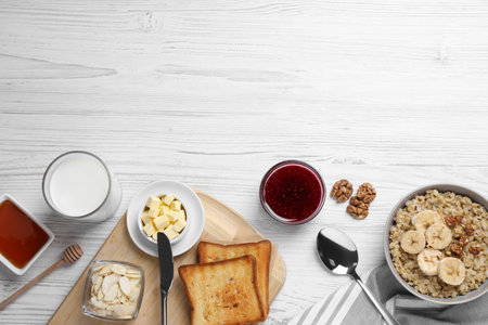Flat lay composition with tasty breakfast food on white wooden table. Space for textの写真素材
