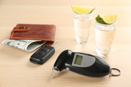 Composition with modern breathalyser  on wooden tableの写真素材