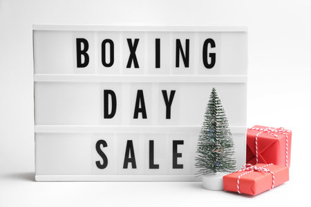 Lightbox with phrase BOXING DAY SALE and Christmas decorations on white backgroundの写真素材