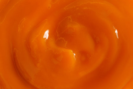 Delicious orange jam as background, closeup viewの写真素材